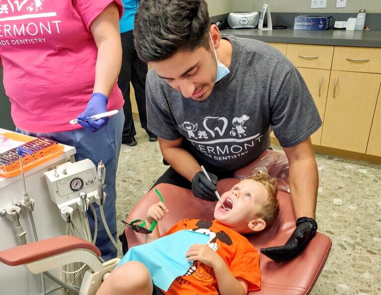 Dr. Faraz treating child's teeth